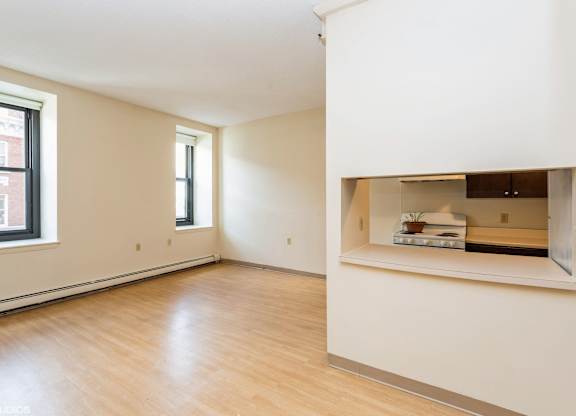 A large empty room with wooden floors and white walls at Mohican Apartments, Connecticut