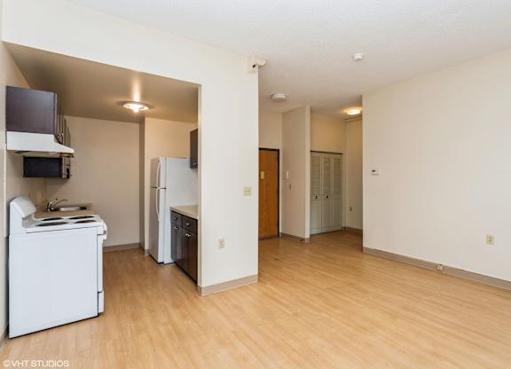 A kitchen with a refrigerator, microwave, and oven at Mohican Apartments, New London, CT