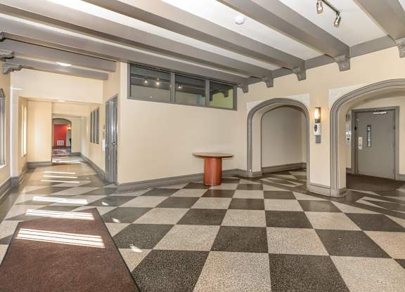A hallway with a checkered floor and a brown carpet at Sheridan Park, Chicago, Illinois
