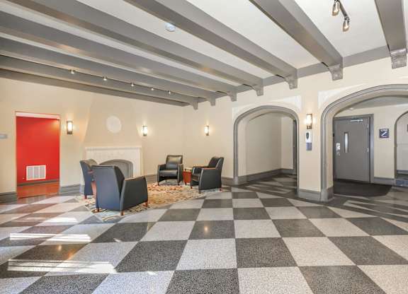 A hallway with a checkered floor and a red door at Sheridan Park, Chicago, IL 60640
