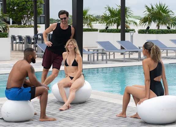 Four people sitting on exercise balls by a pool. at Palma, Florida, 33166