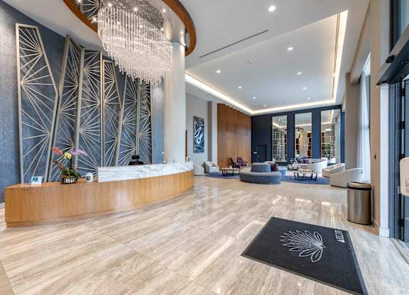 A reception area with a wooden desk  at Palma, Doral, FL, 33166