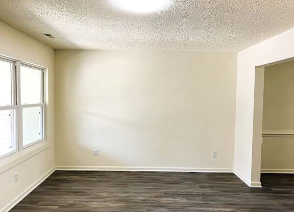 A room with a window and a door.