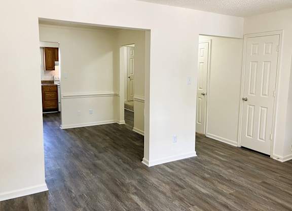 A room with white walls and wood flooring.