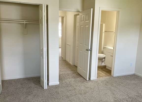 A white door is open to a bathroom.