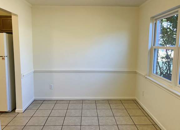 A room with a tiled floor and a window.