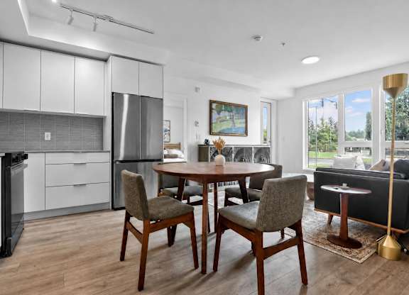 A modern kitchen with a dining table and chairs.
