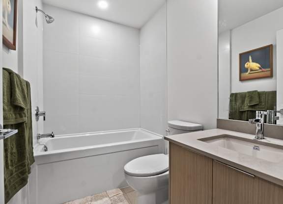 A bathroom with a toilet, sink, and bathtub.