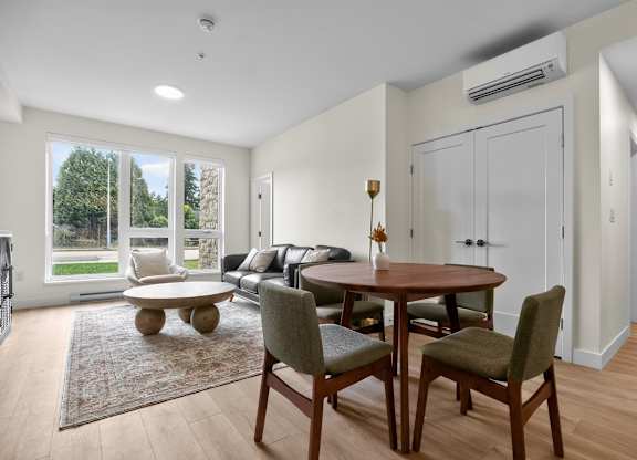 A dining room with a table and chairs.