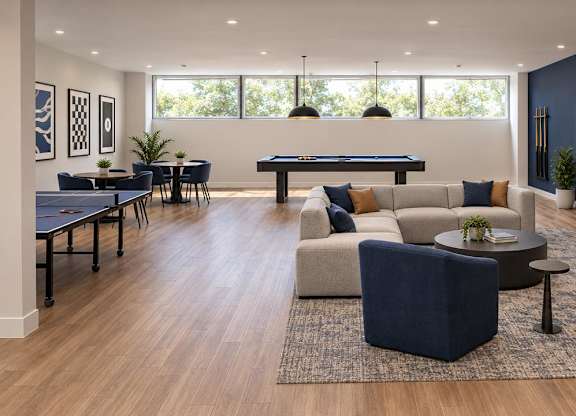 A modern living room with a pool table and comfortable seating.