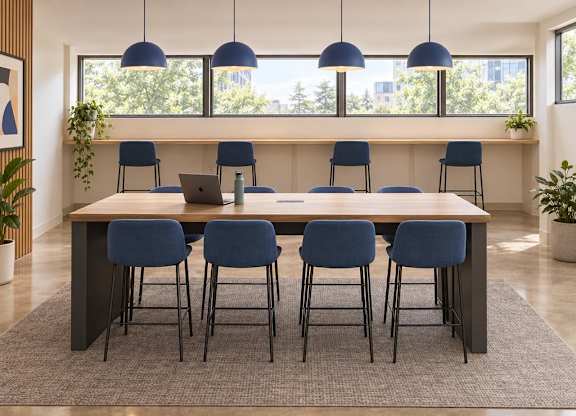 A conference room with a long table and blue chairs.
