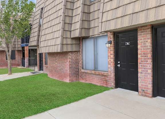 A building with black doors and windows numbered 104 and 105.