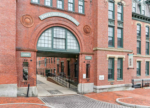 The entrance to Baker Chocolate Factory is made of red brick.