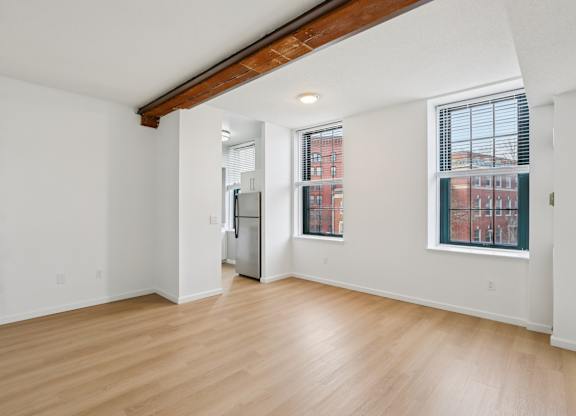 A room with wooden floors and white walls.