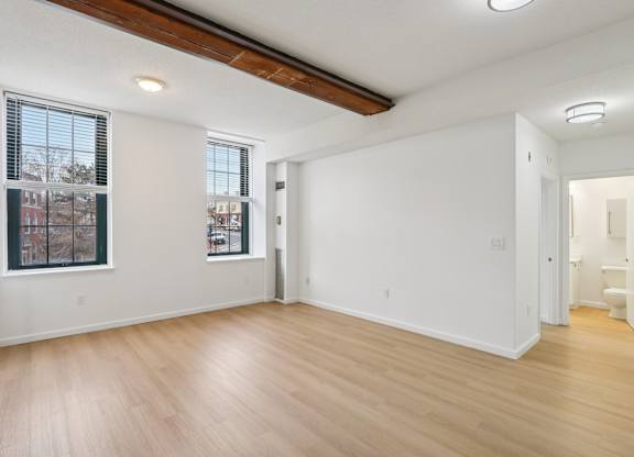 A room with wooden floors and white walls.