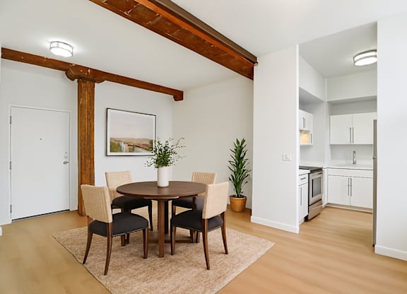 A dining room with a table and chairs.