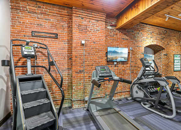 A gym with treadmills and a stair climber.