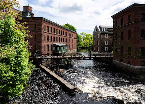 A river flows between two buildings.