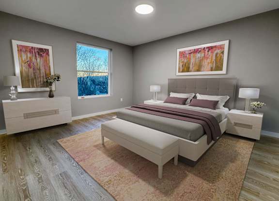 A bedroom with a large bed and a painting on the wall.