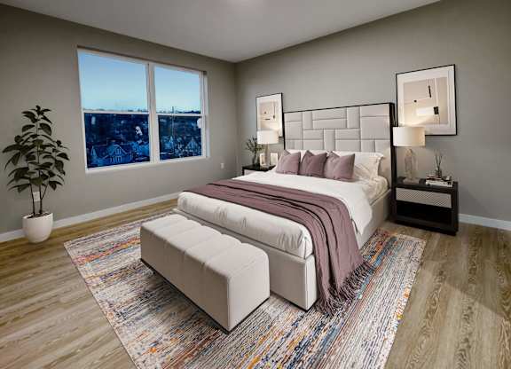 A bedroom with a large bed, a bench, and a potted plant.