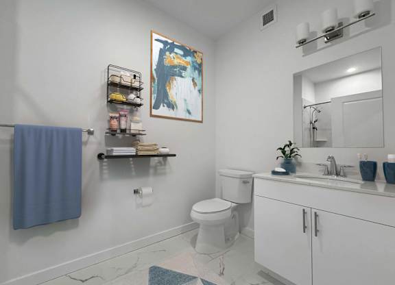 A bathroom with a toilet, sink, and a blue towel hanging on the wall.