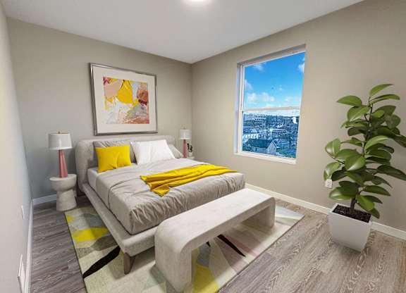 A bedroom with a bed, a bench, and a potted plant.
