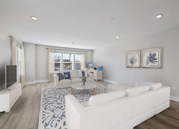 A living room with a white couch and a television.