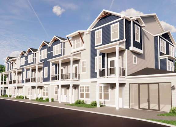A row of townhouses with balconies and garages.