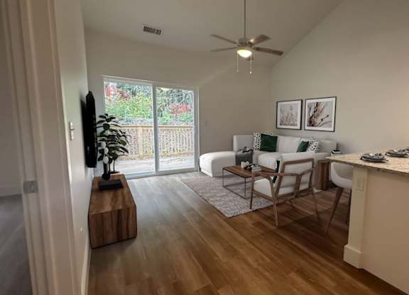 A kitchen with a counter and a dining table with chairs.