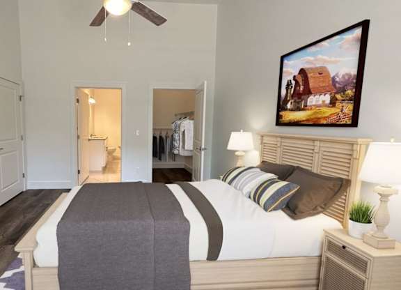 A bedroom with a bed, dresser, and ceiling fan.