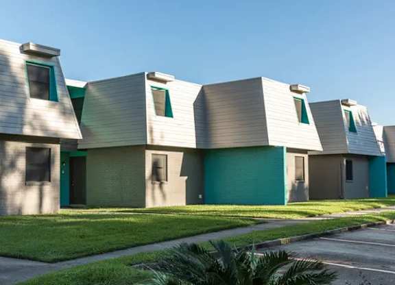A series of houses with green doors and windows.