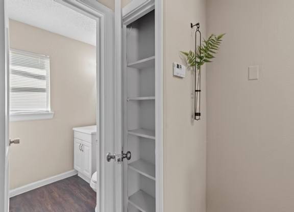 A white door with a plant on the side.