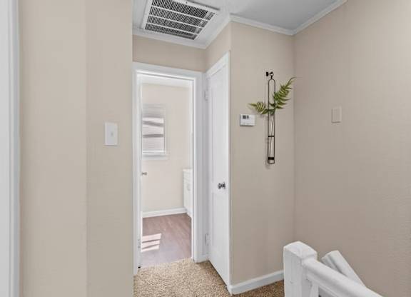 A white door is open to a hallway.