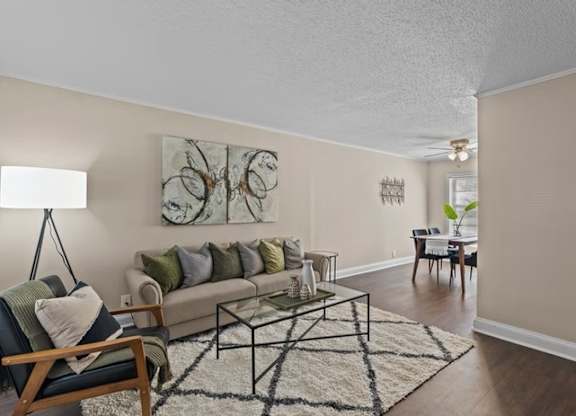 A living room with a couch, a chair, and a coffee table.