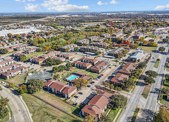 A bird's eye view of a residential area with houses and roads.