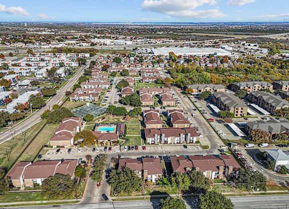 A bird's eye view of a residential area with houses and roads.