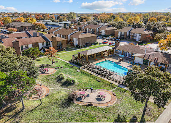 A large apartment complex with a pool and a playground.