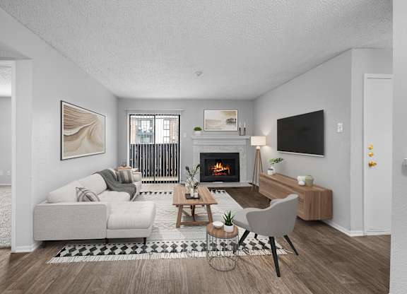 A modern living room with a fireplace and a grey sofa.