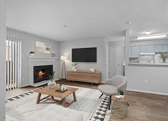 A modern living room with a fireplace and a flat screen TV.