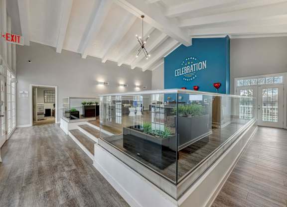 A spacious room with a glass display case in the center and a sign that reads "CELEBRATION".