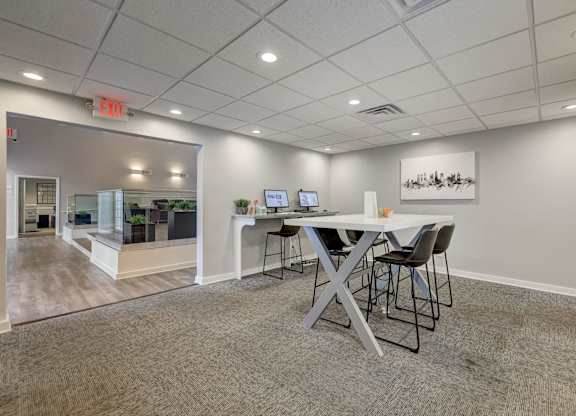 A conference room with a table and chairs.