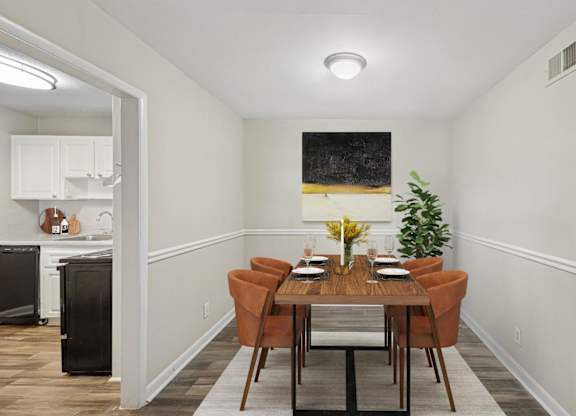 A dining room with a wooden table and chairs.