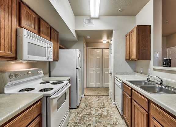 A kitchen with a stove top oven and microwave above it.
