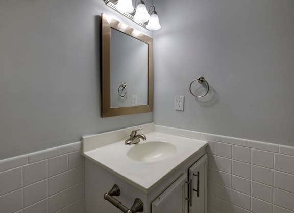 A bathroom sink with a mirror above it at Retreat at Savannah Apartments, Georgia