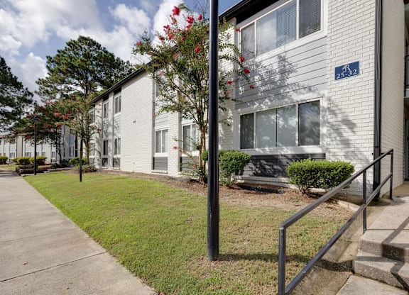 A white building with a blue sign on the front at Retreat at Savannah Apartments, Savannah, GA, 31404