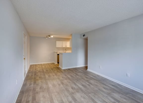 A room with wooden flooring and white walls at Retreat at Savannah Apartments, Savannah, GA