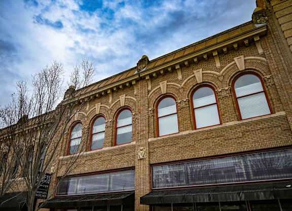 A building with arched windows and a brick facade.