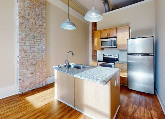 A kitchen with a sink and a refrigerator.