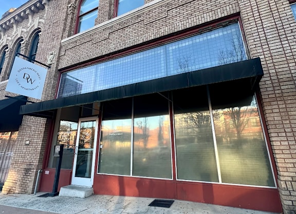 A building with a red door and windows.