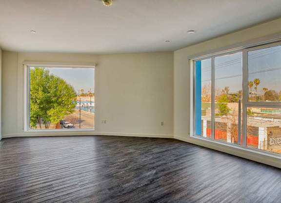 A room with a large window overlooking a street.at Catalina West Adams, California